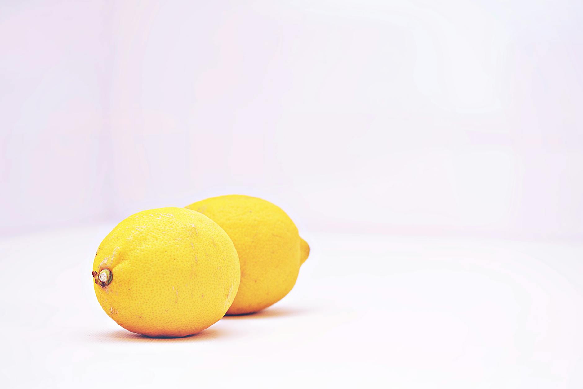 Colorful lemon sexual toys and vibrators arranged on a bright yellow surface
