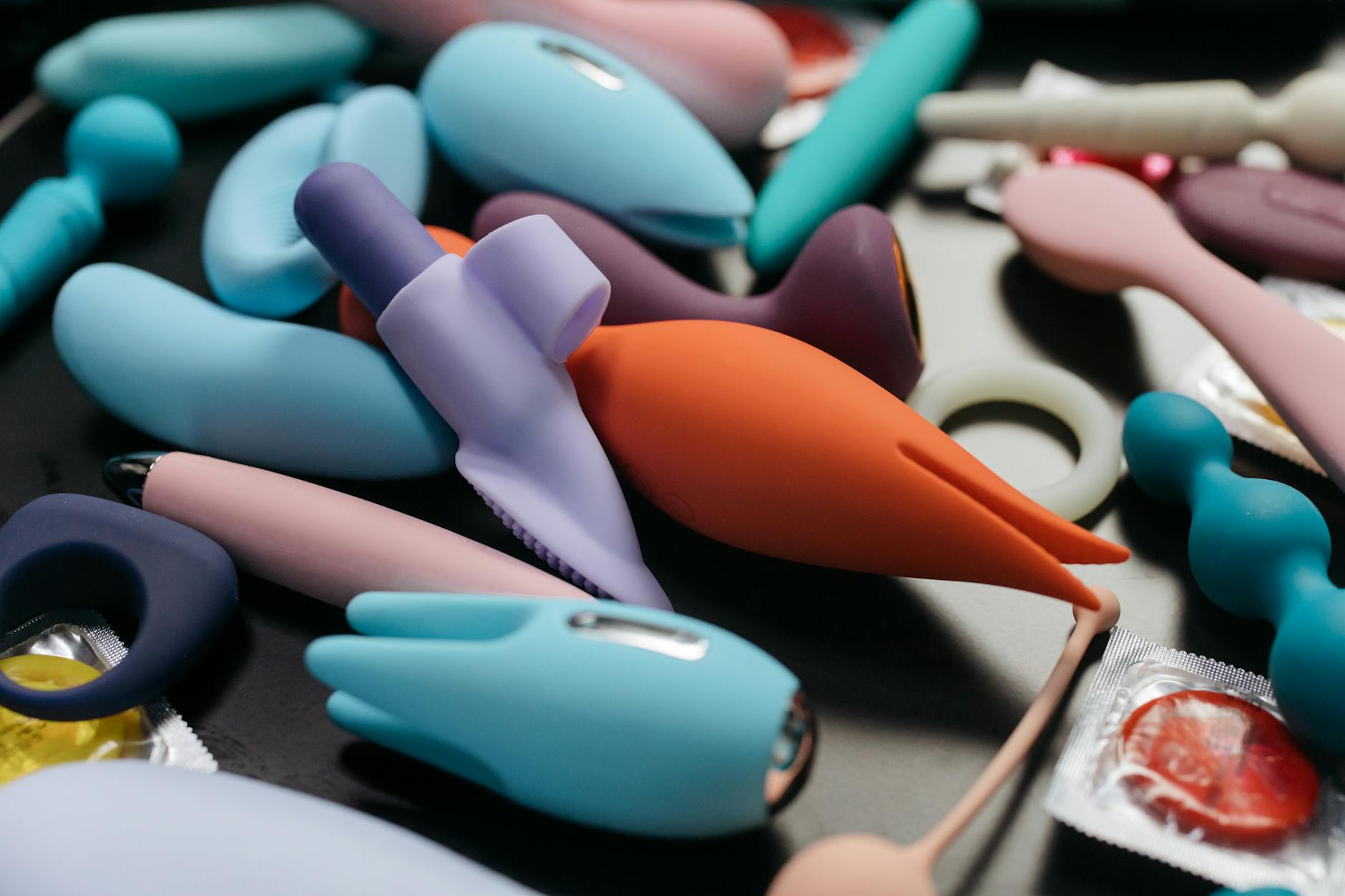 A hand holding a vibrator against a minimalistic purple backdrop showcasing modern sensuality.